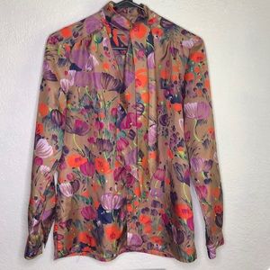 Multi-color floral womansblong sleeve blouse with neck tie.